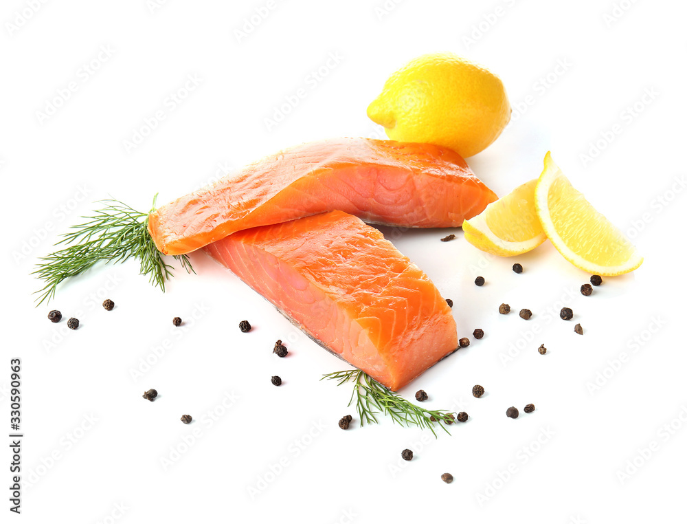 Raw salmon fillet with spices and lemon on white background