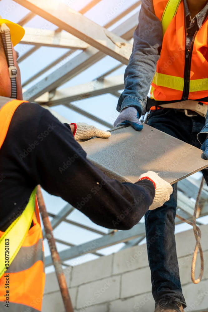 Workers wearing yellow safety helmets are working with concrete aerated blocks wall,Lightweight conc