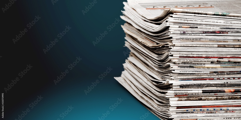 Pile of newspapers stacks on blur background