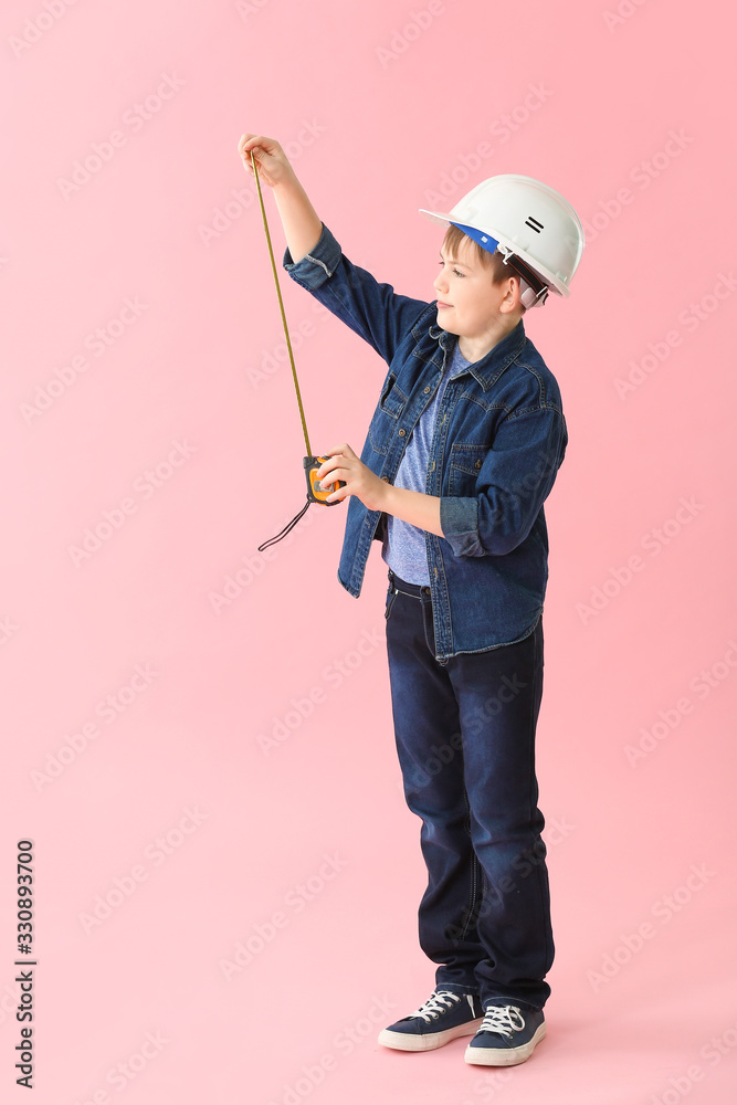 Cute little builder on color background