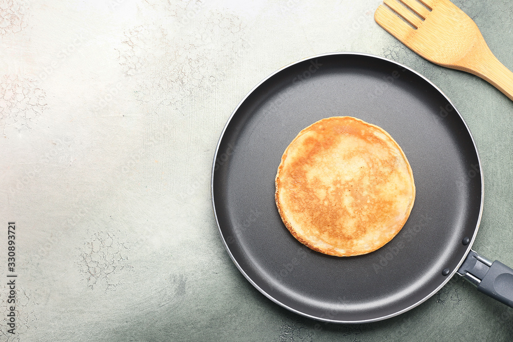 Preparing of tasty pancakes in frying pan