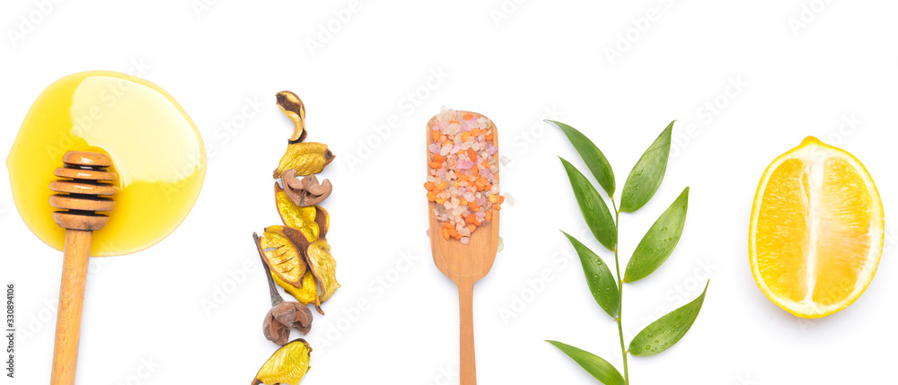 Composition with honey, sea salt and lemon on white background