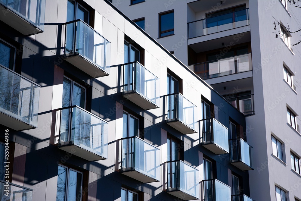 Modern apartment buildings on a sunny day with a blue sky. Facade of a modern apartment building