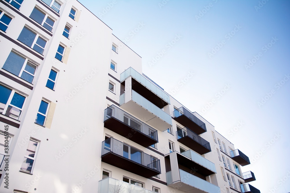 Modern apartment buildings on a sunny day with a blue sky. Facade of a modern apartment building