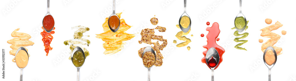 Spoons with different tasty sauces on white background, top view