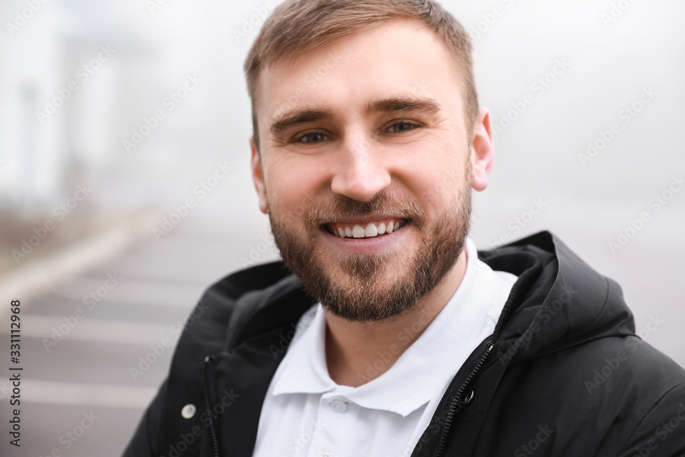 Happy smiling young man outdoors