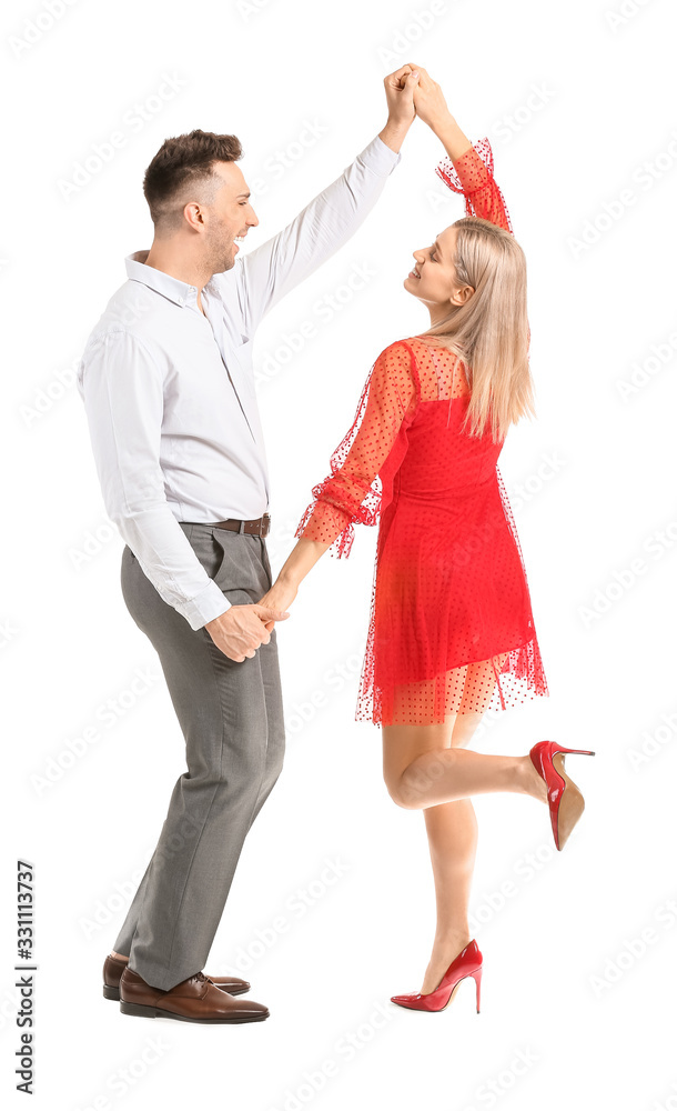 Happy dancing young couple on white background