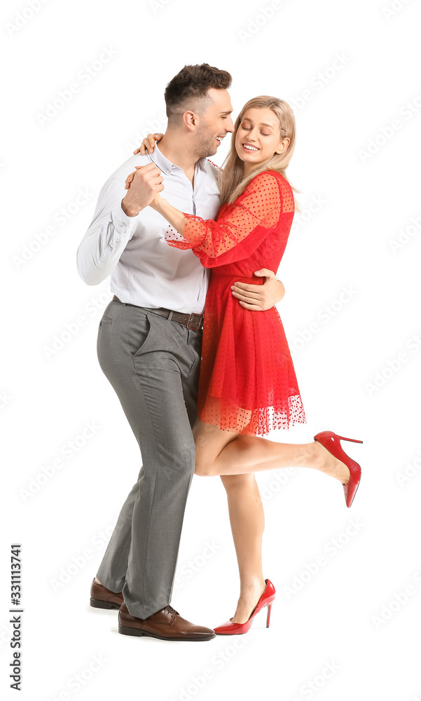 Happy dancing young couple on white background