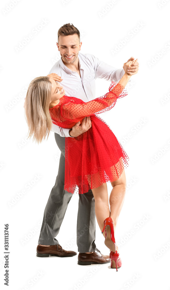 Happy dancing young couple on white background