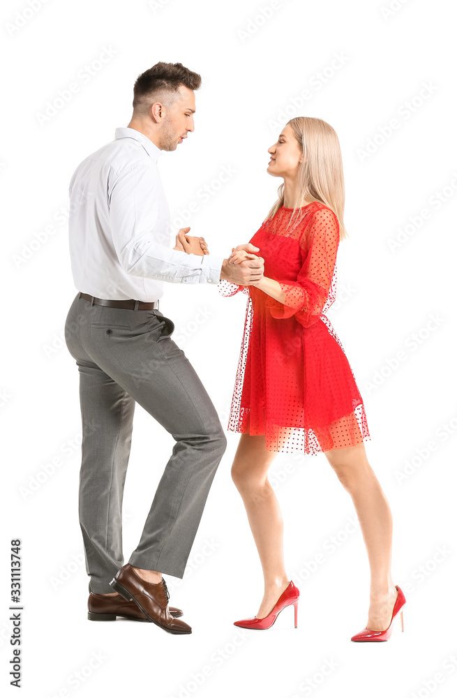 Happy dancing young couple on white background