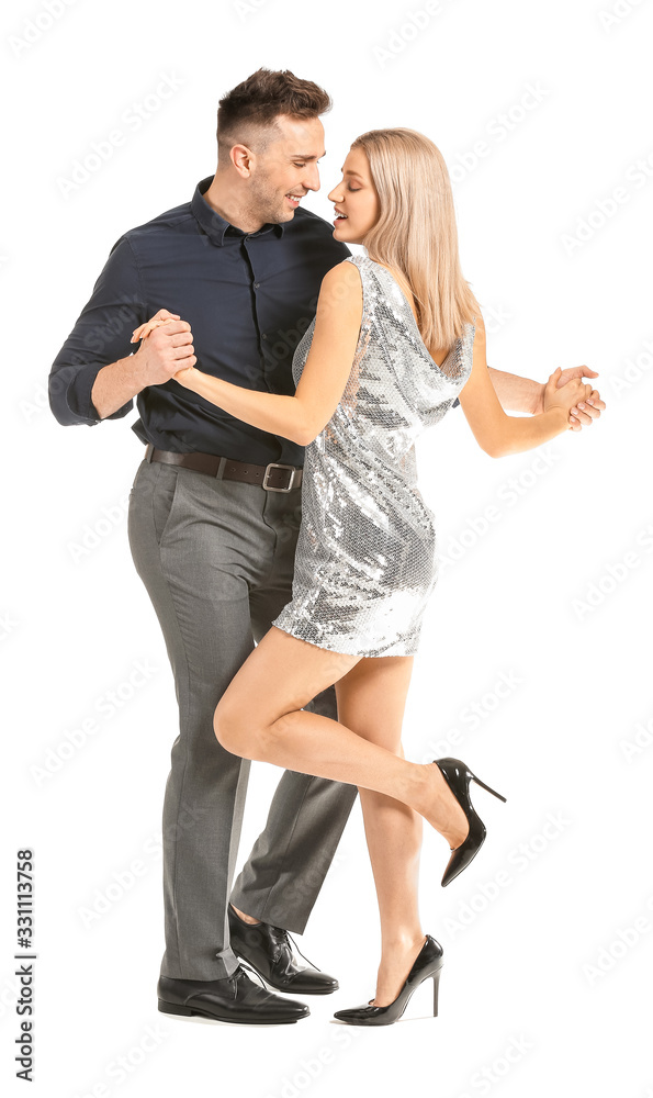 Happy dancing young couple on white background