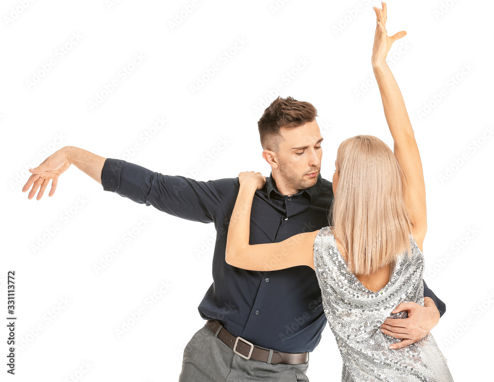 Happy dancing young couple on white background