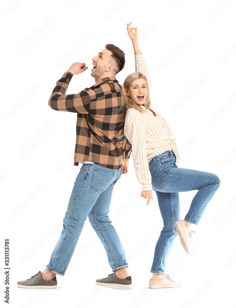 Happy dancing young couple on white background