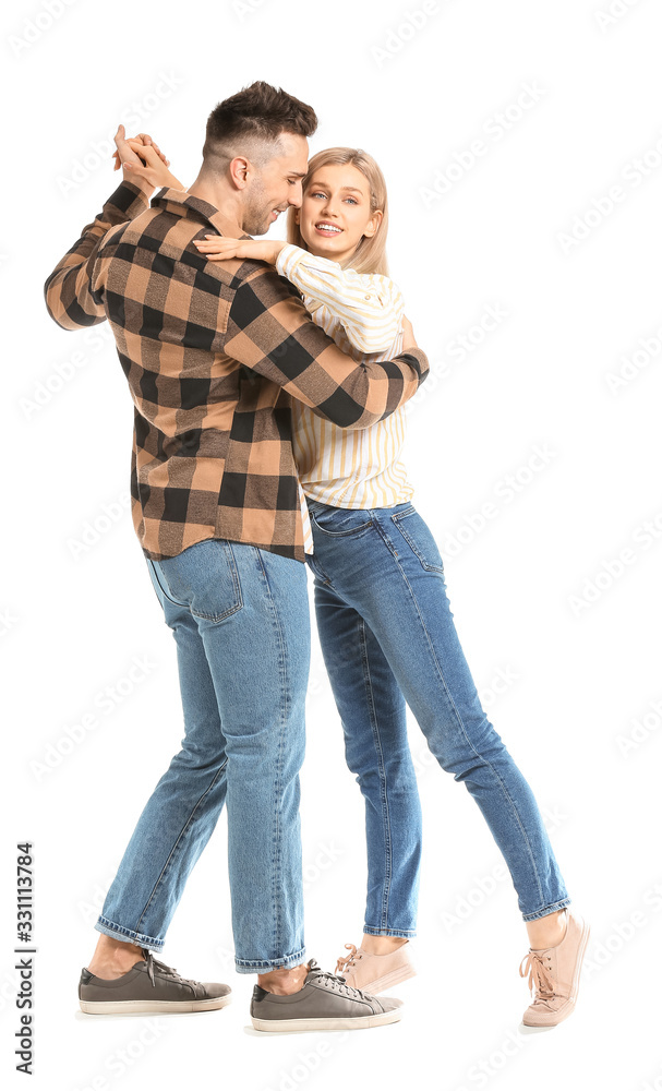 Happy dancing young couple on white background