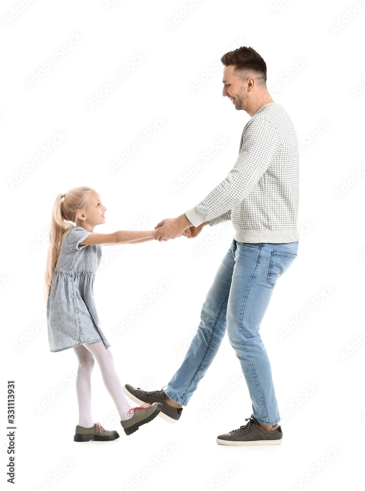 Man and his little daughter dancing against white background