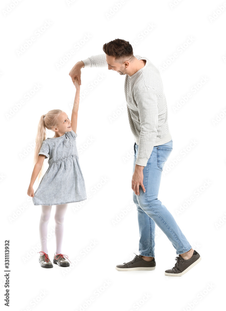 Man and his little daughter dancing against white background