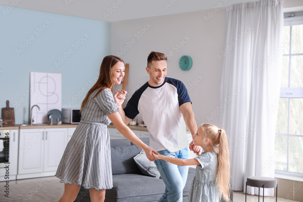 Happy family dancing in kitchen