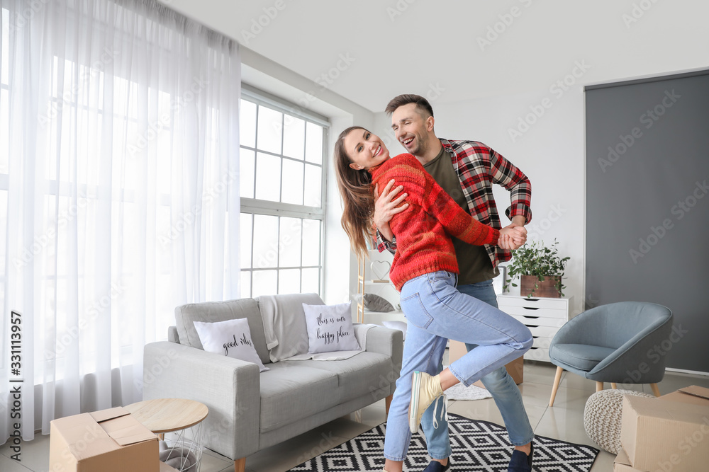 Happy couple dancing at home