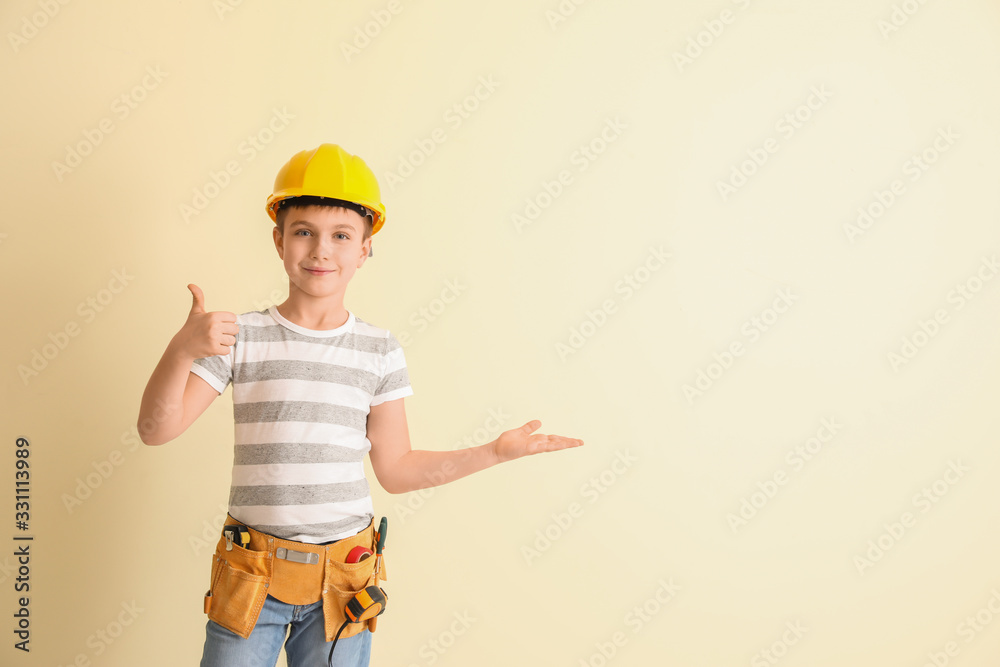 Cute little architect showing thumb-up on light background