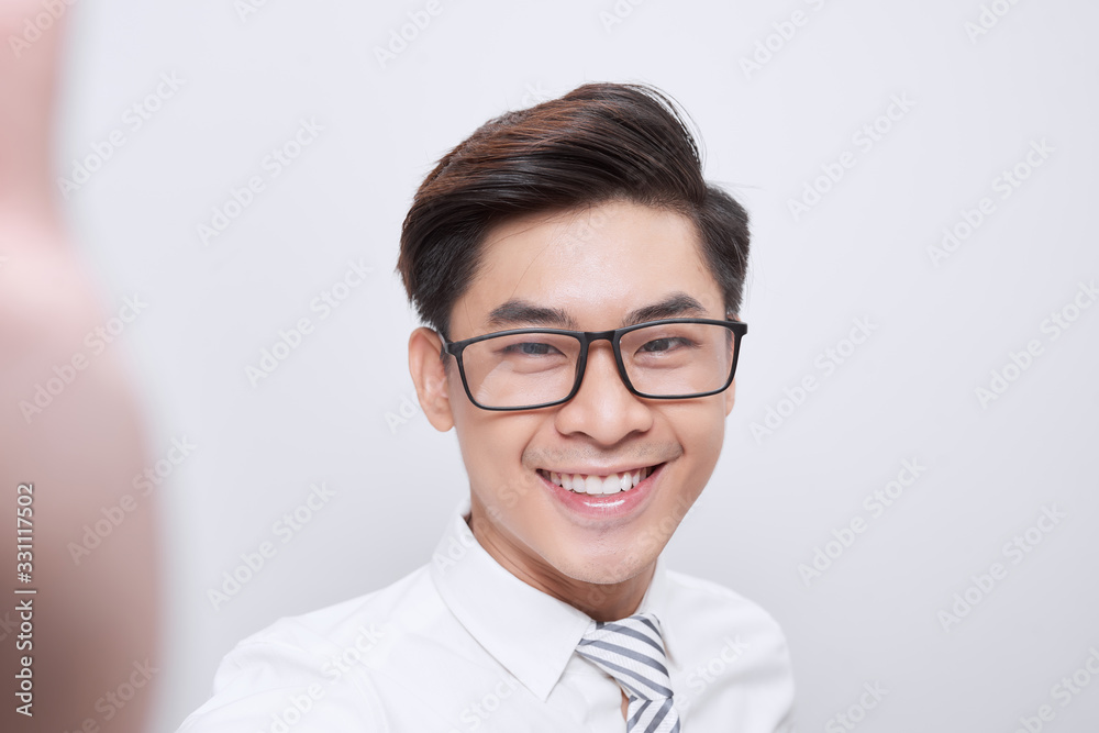 Selfie mania! Excited young guy is making selfie on a camera.