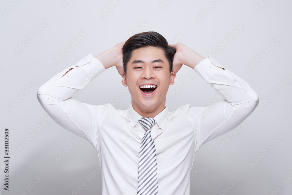 handsome excited surprised man happy smile looking at camera, hold hands on head, young guy wear whi