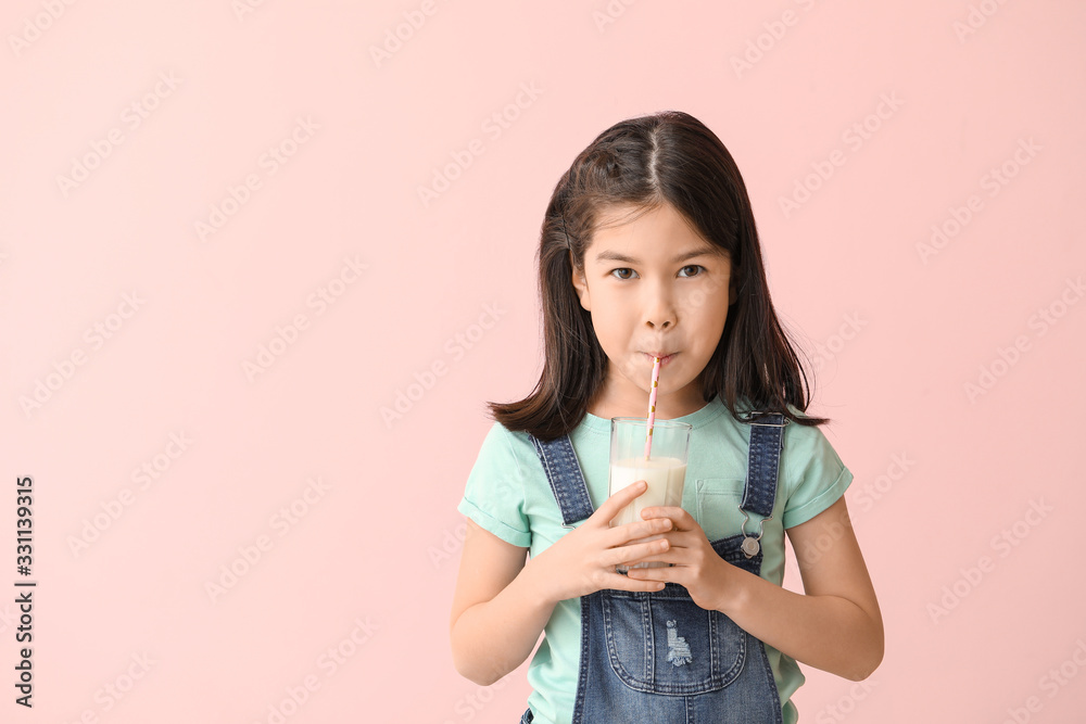 Cute Asian girl with milk on color background