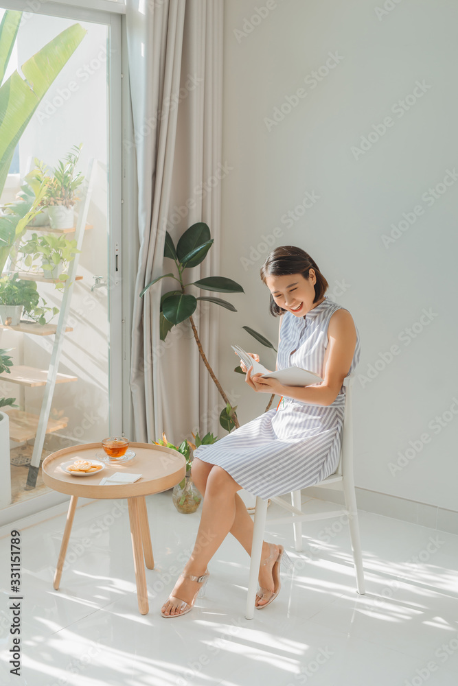 beautiful asian woman reading a book