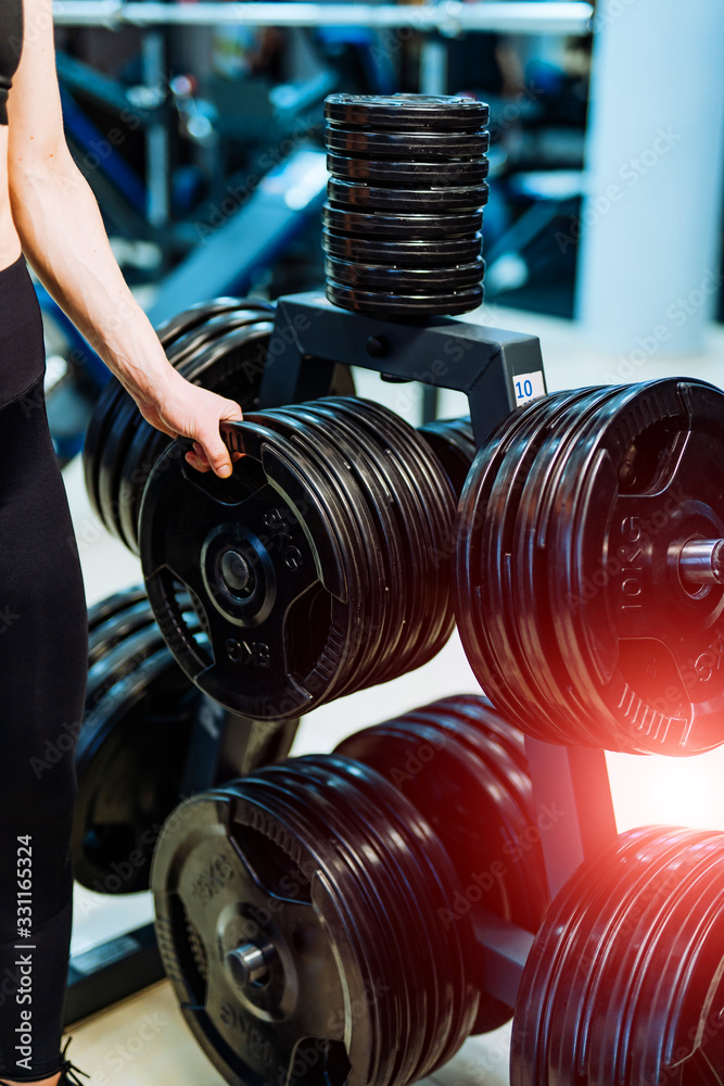 Huge pancakes for a dumbbell in a gym. Sport and healthy life concept. Set of pancakes on gym backgr