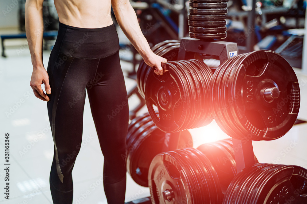 Pancakes for a dumbbell in a gym. Sport and healthy life concept. Set of pancakes on gym background.