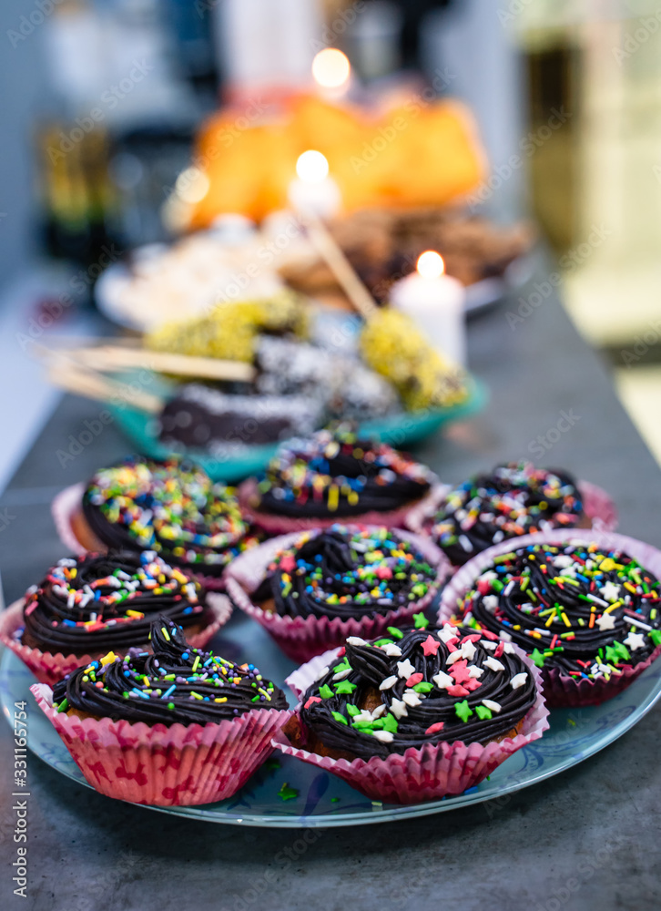 Dessert table for a party. Cake, cupcakes, sweetness and bright colors.