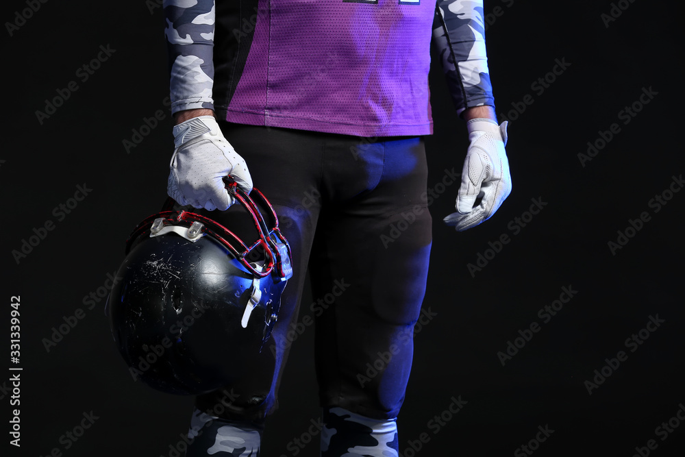 American football player on dark background