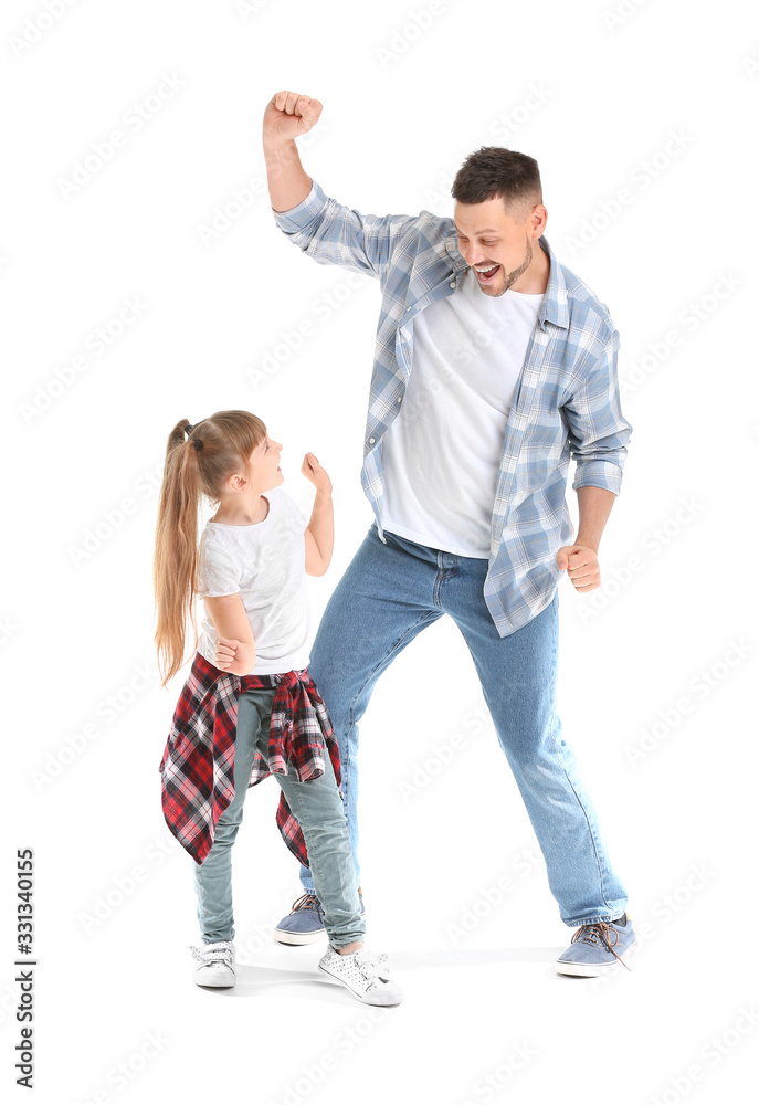 Father and his little daughter dancing against white background