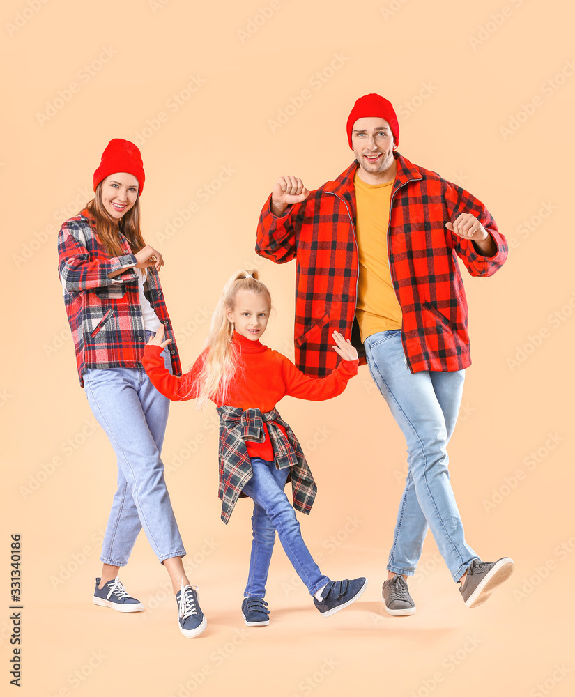 Happy family dancing against color background