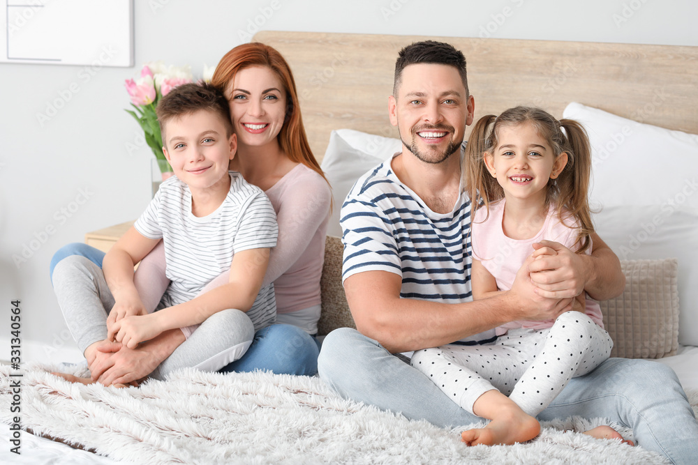 Happy family in bedroom at home