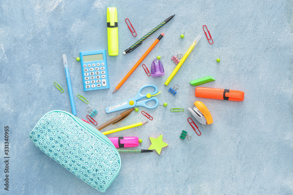 Pencil case and school stationery on color background