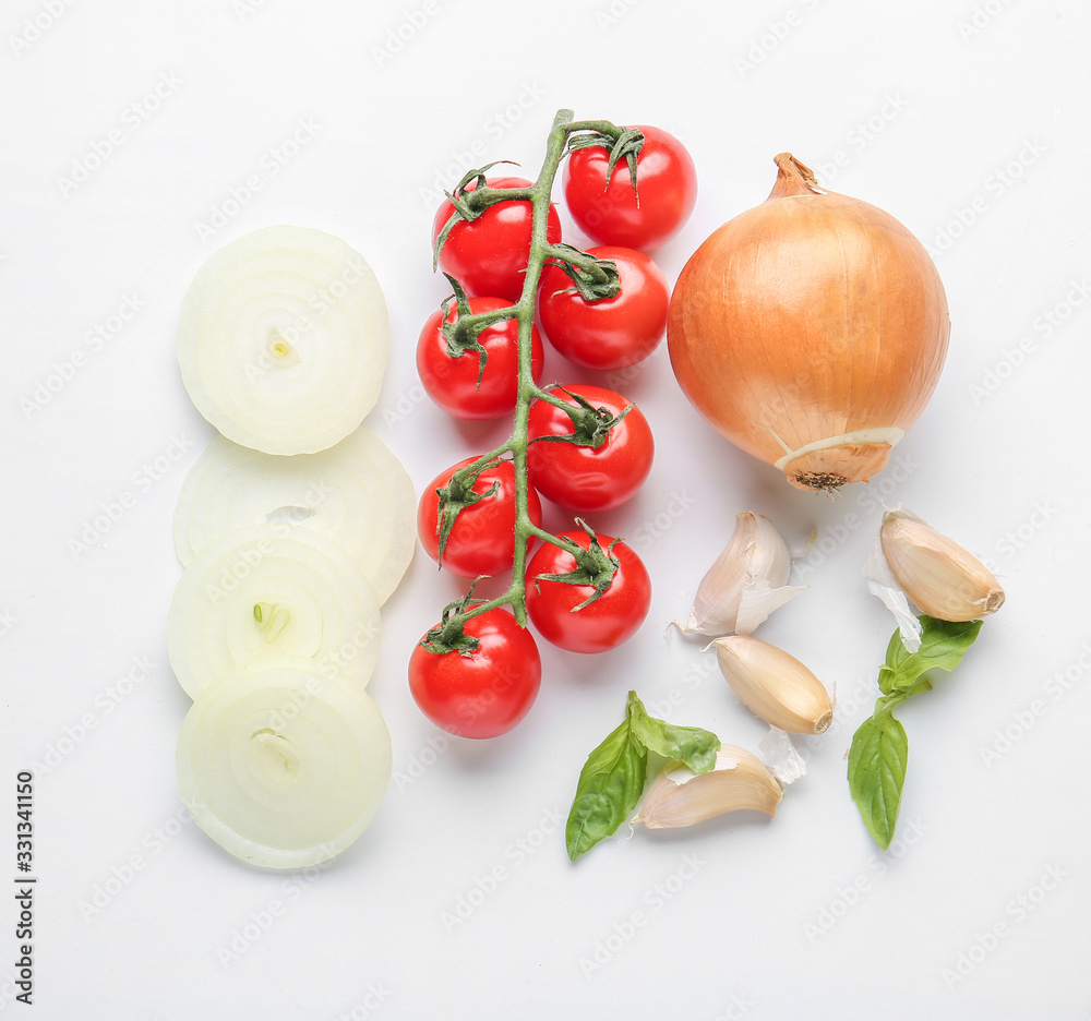 Fresh raw onion, tomato and spices on white background