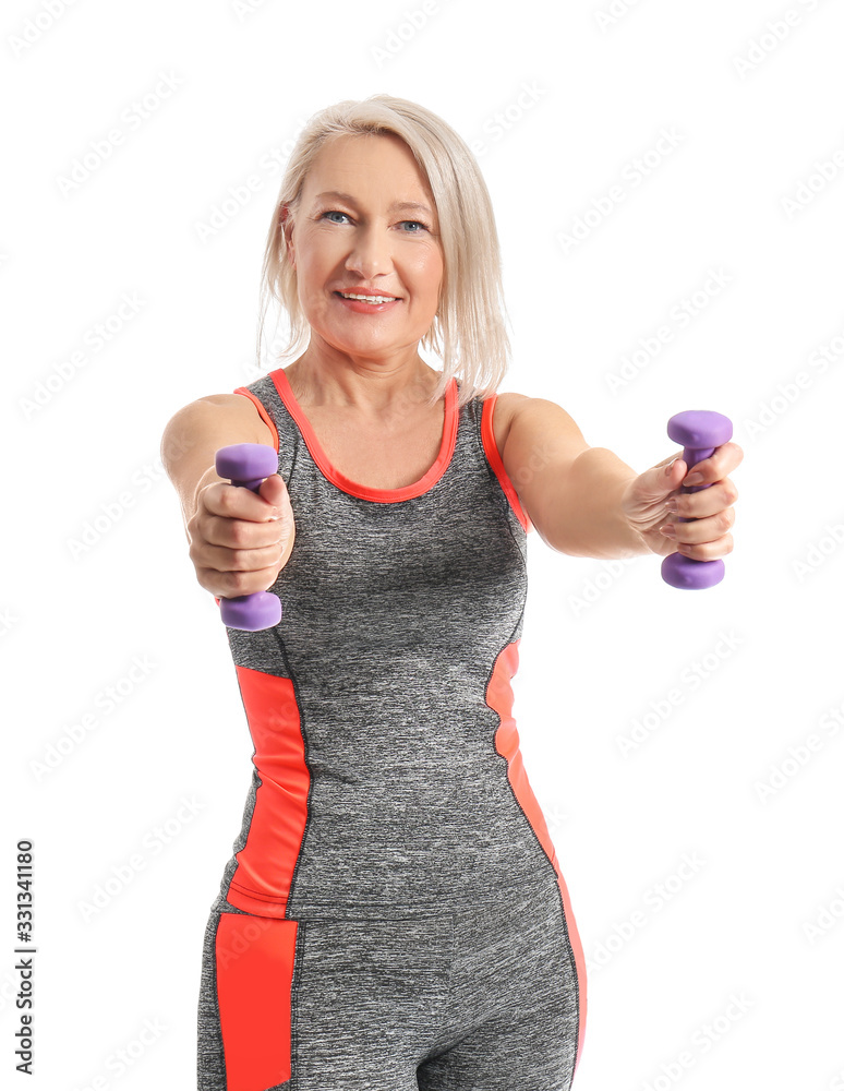 Sporty mature woman with dumbbells on white background