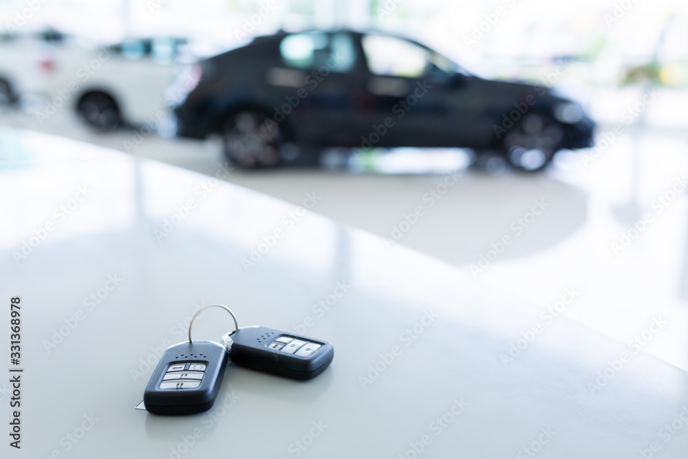 New key in car showrooms with two new remote keys placed on the work table in the new car showroom.