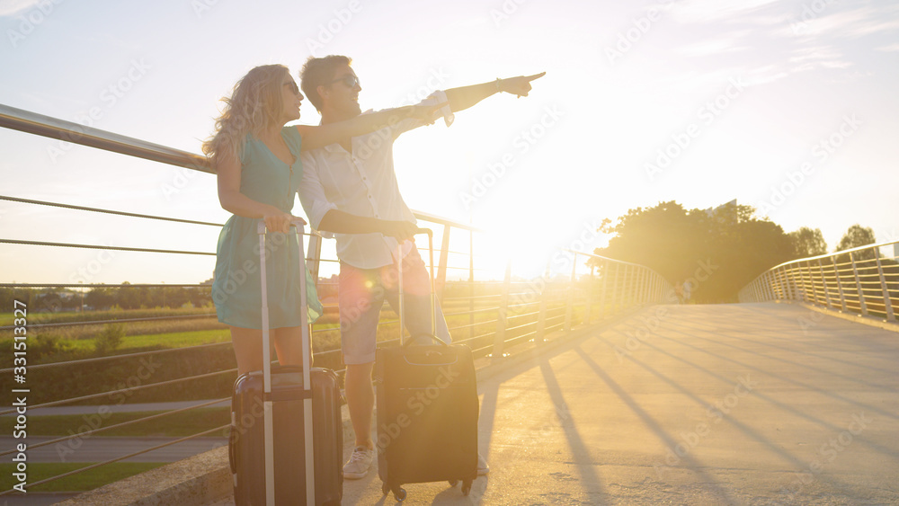 SUN FLARE: Excited tourist couple points at their ride taking them to airport.