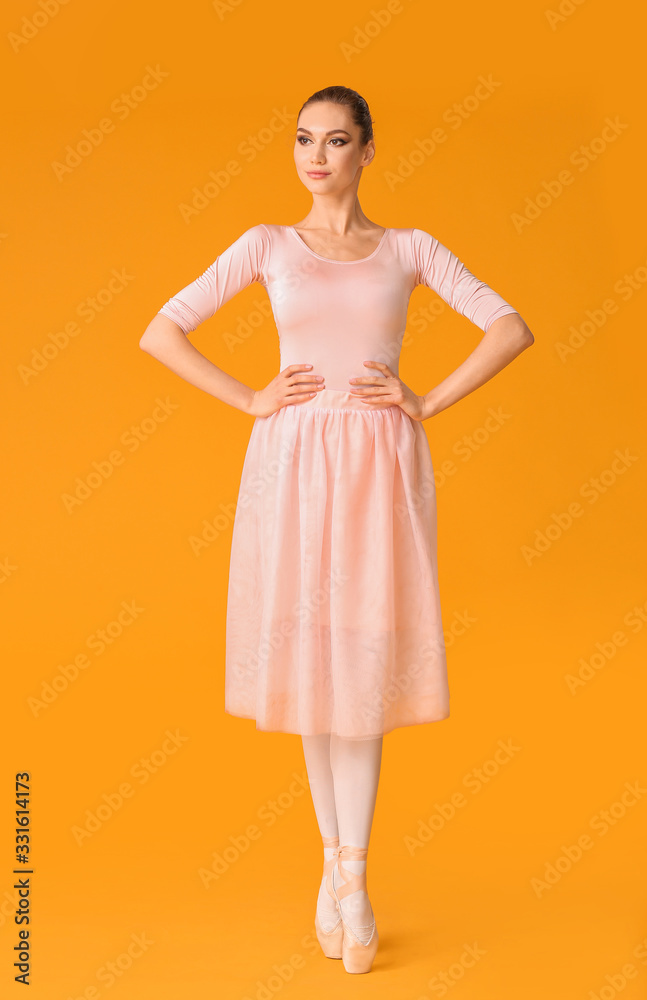 Beautiful young ballerina on color background