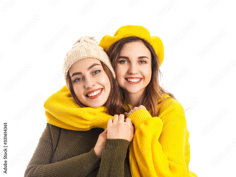 Young women in warm sweaters on white background