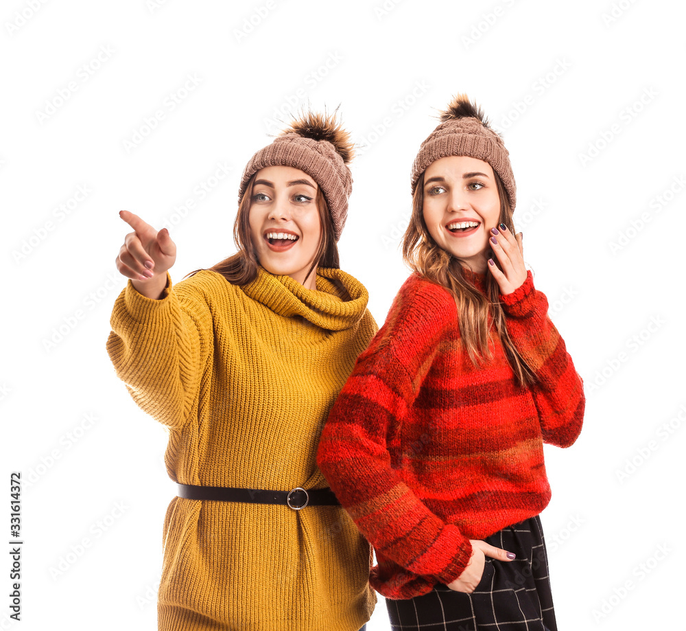 Young women in warm sweaters on white background