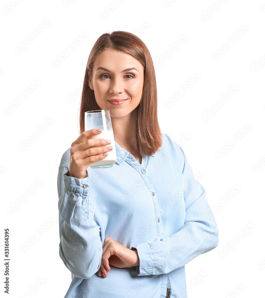 Beautiful young woman with glass of milk on white background