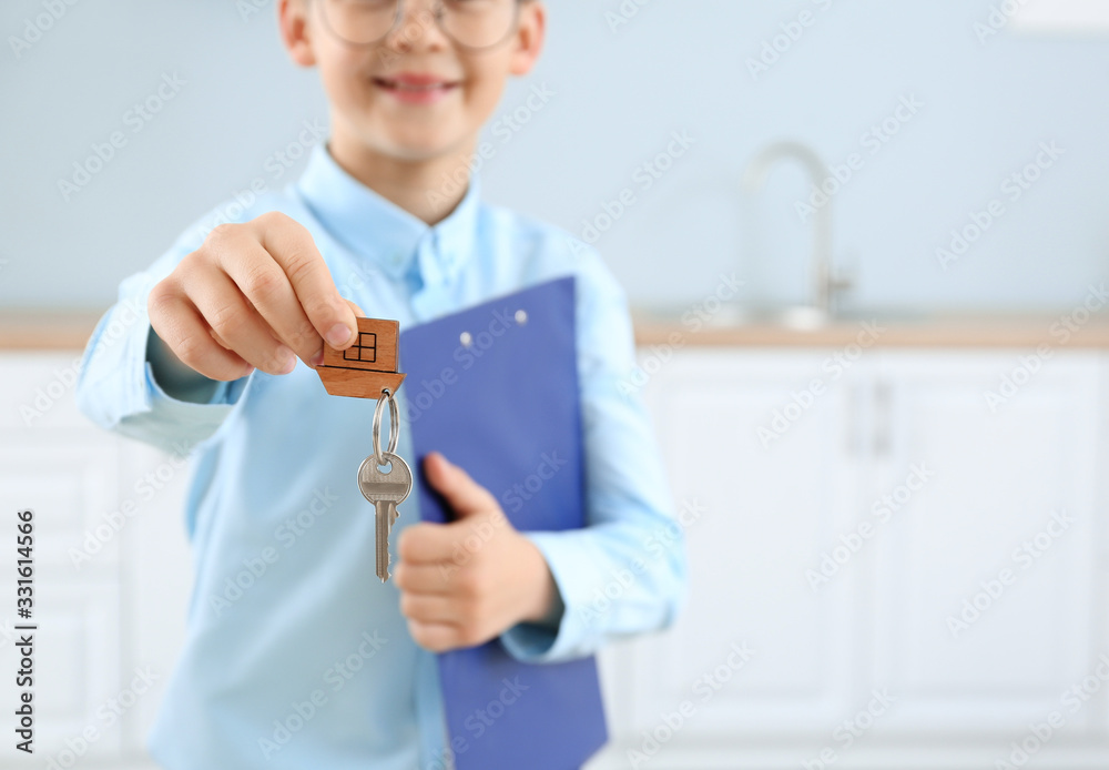 Little real estate agent with key indoors