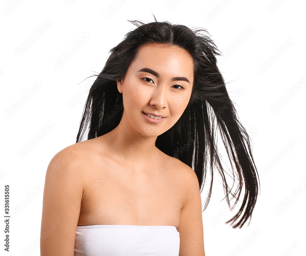 Young Asian woman with beautiful long hair on white background