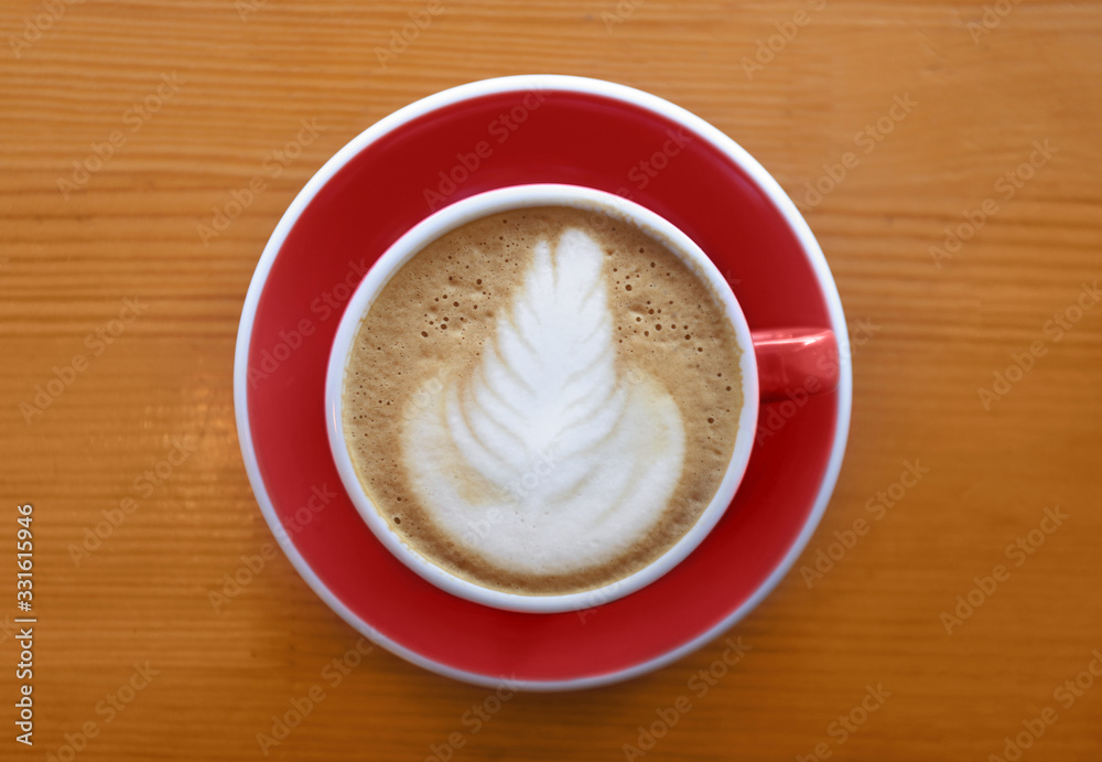 Cup of tasty cappuccino on wooden table