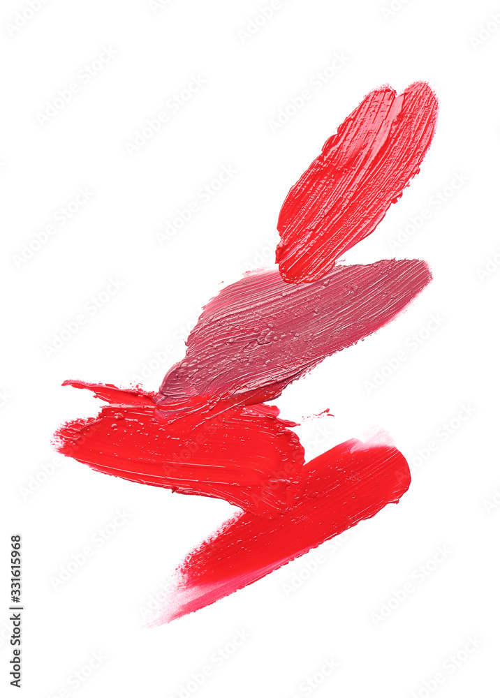 Strokes of bright lipsticks on white background