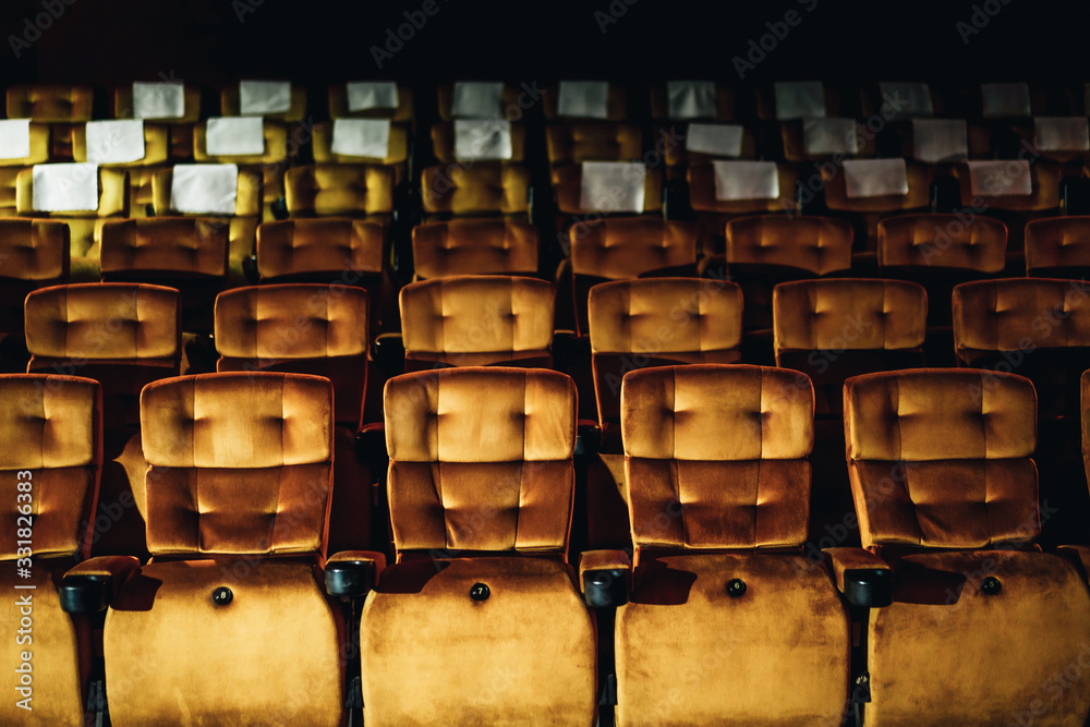 A row of yellow seat in the movie theater