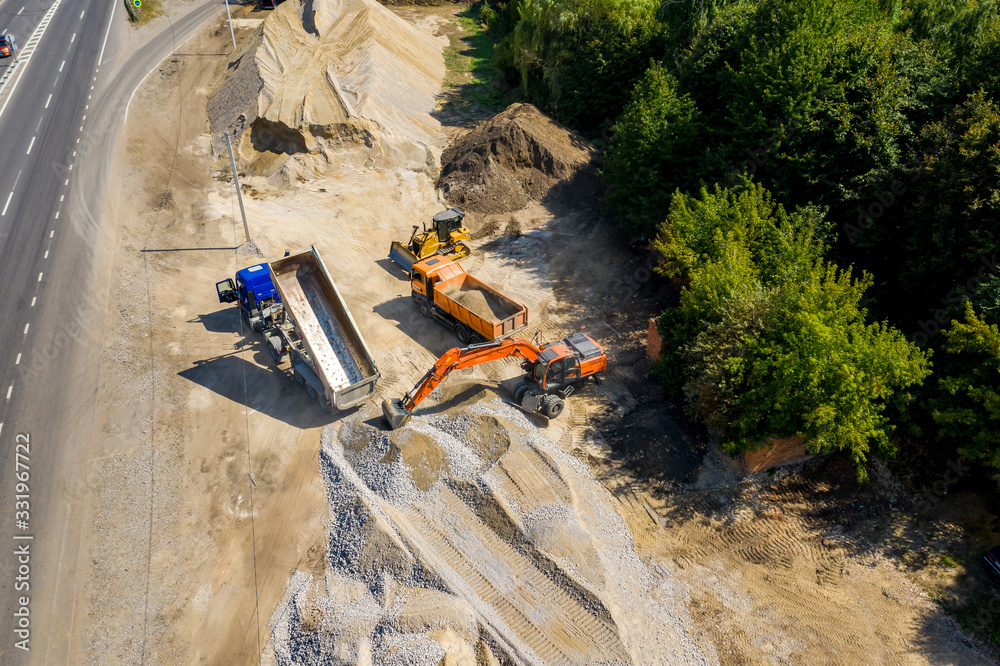 Construction site, construction machinery, bulldozer, excavation, factory. Aerial view.