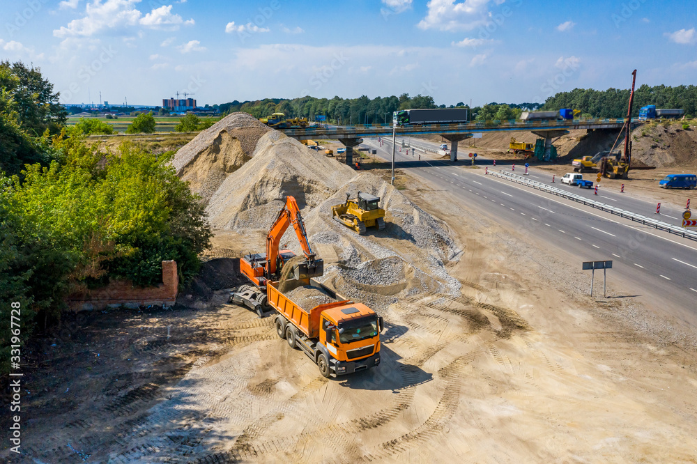 Heavy machinery on a construction site against blue sky.Aerial view.